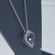 Load and play video in Gallery viewer, Jewelili Sterling Silver With Heart Shape Created Blue Sapphire and Round Shape Created White Sapphire Diamonds Pendant Necklace
