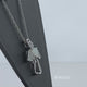 Load and play video in Gallery viewer, Jewelili Sterling Silver with Created Opal and Cubic Zirconia Angel Pendant Necklace
