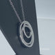 Load and play video in Gallery viewer, Jewelili Sterling Silver With Round White Diamonds Multi Circle Pendant Necklace
