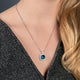 Load image into Gallery viewer, Jewelili Sterling Silver With Cushion Cut Swiss Blue Topaz, Round White Topaz and Round Emerald Halo Pendant Necklace, 18&quot; Box Chain
