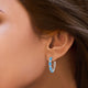 Load image into Gallery viewer, Jewelili Hoop Earrings with Oval Cut Swiss Blue Topaz and Round Created White Sapphire over Sterling Silver view 2
