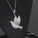 Load and play video in Gallery viewer, Jewelili Sterling Silver With Created Opal and Diamonds Dove Pendant Necklace
