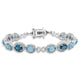 Load image into Gallery viewer, Jewelili Tennis Bracelet with Oval Swiss &amp; London Blue Topaz and Round White Diamonds in Sterling Silver View 1
