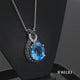 Load and play video in Gallery viewer, Jewelili Sterling Silver with 1/3 CTTW Treated Blue Diamonds and White Diamonds with Blue Topaz Knot Pendant Necklace
