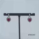 Load and play video in Gallery viewer, Jewelili Sterling Silver with Created Ruby and Created White Sapphire Twisted Dangle Earrings
