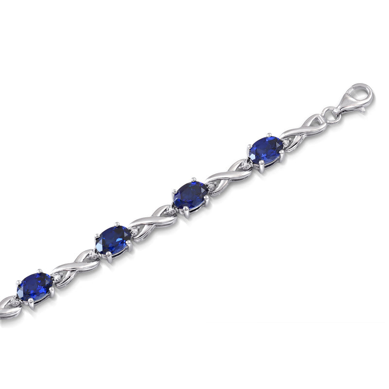 Jewelili Sterling Silver 7x5 mm Oval Shape Created Blue Sapphire and White Diamonds Bracelet, 7.25"