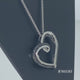 Load and play video in Gallery viewer, Jewelili Sterling Silver 1/3 CTTW Treated Black Diamonds and White Diamonds Tilted Heart Pendant Necklace
