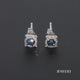 Load and play video in Gallery viewer, Jewelili Sterling Silver With 1/4 CTTW Treated Blue Diamonds and White Diamonds Stud Earrings
