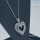 Load and play video in Gallery viewer, Jewelili Sterling Silver With 1/4 CTTW Round and Tapered Baguette Diamonds Heart Pendant Necklace
